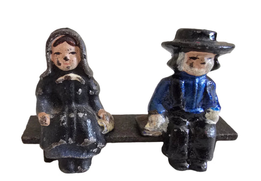 vintage cast iron amish boy and girl on bench