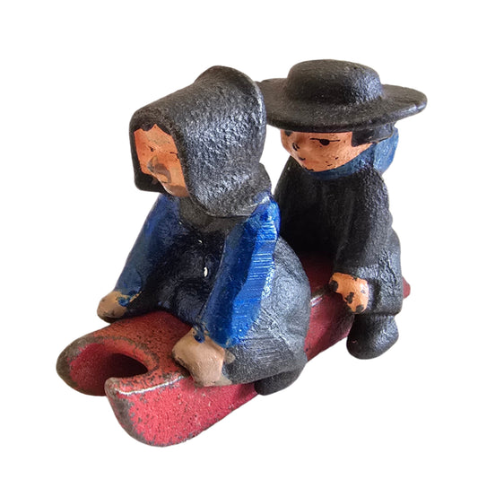 vintage cast iron amish boy and girl on sled